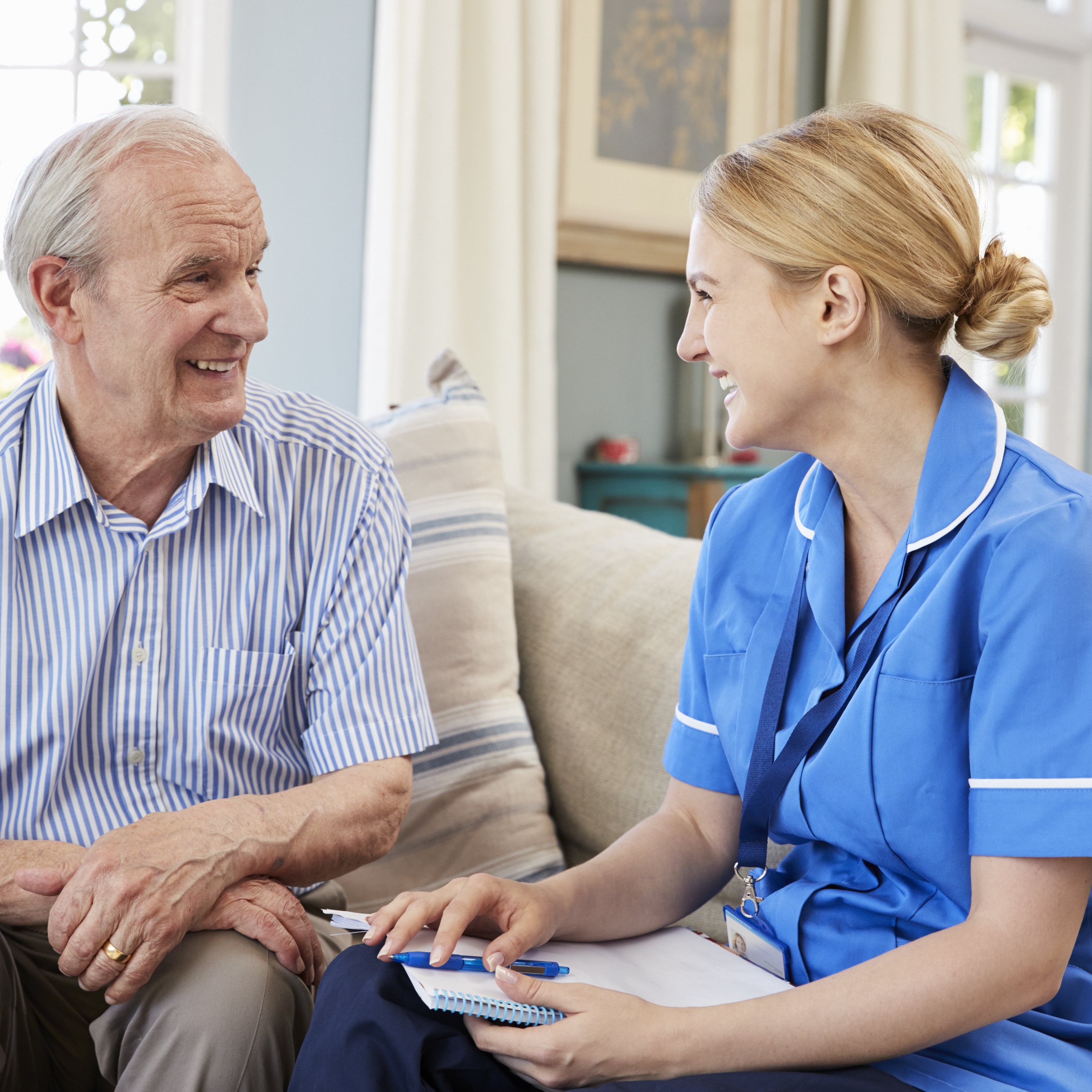 Female Community Nurse Visits Senior Man At Home